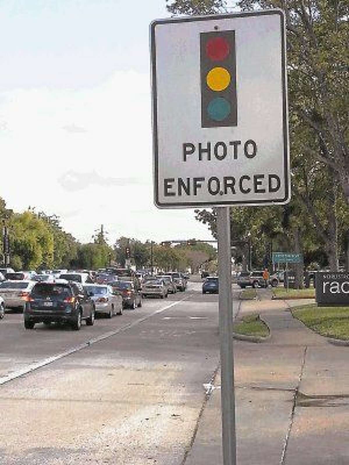 A sign announces the presence of a red ligh camera to drivers on State Highway 6 near its intersection with Lexington Boulevard.