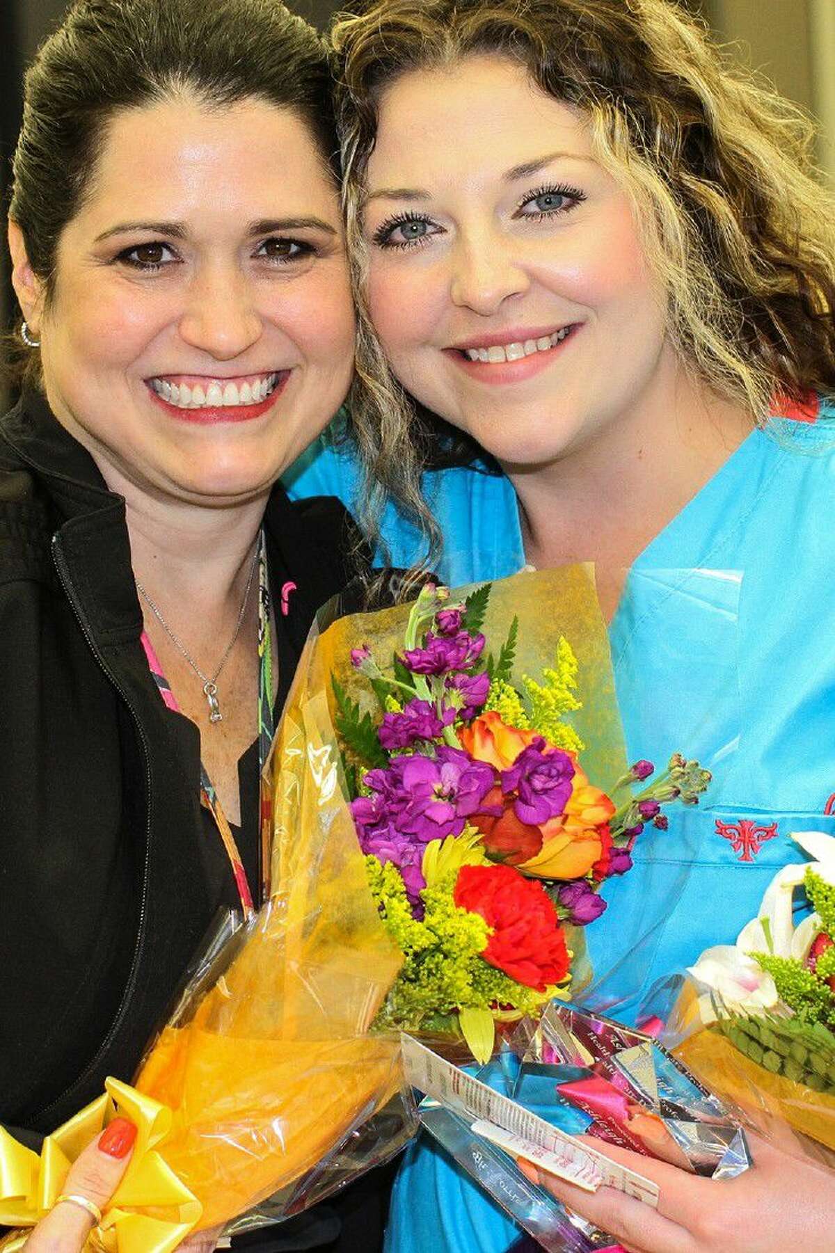 Teague Elementary nurse and mentor Nikki Seymour congratulates Fisher Elementary nurse Ashleigh Morris on her accomplishment.