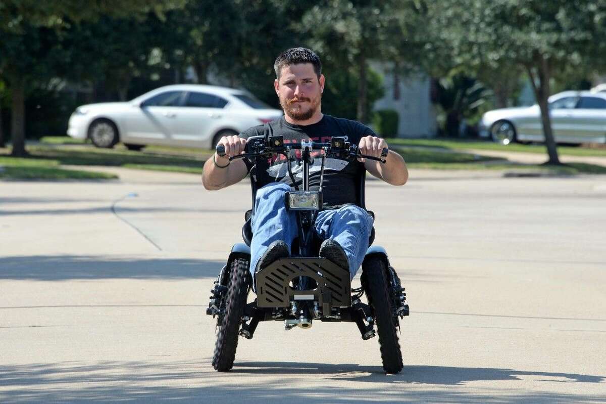 Marine Corps veteran Paul Gardner takes his new Zoom chair for a test drive. The all-terrain vehicle climbs uphill and navigates through sand.