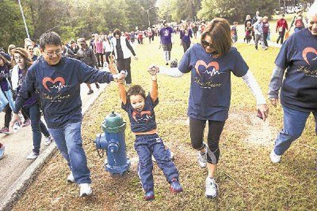The Wang family conquers a fire hydrant "obstacle" during the Greater Lake Houston Heart & Stroke Walk on Nov. 8, 2014, at Lone Star College-Kingwood.