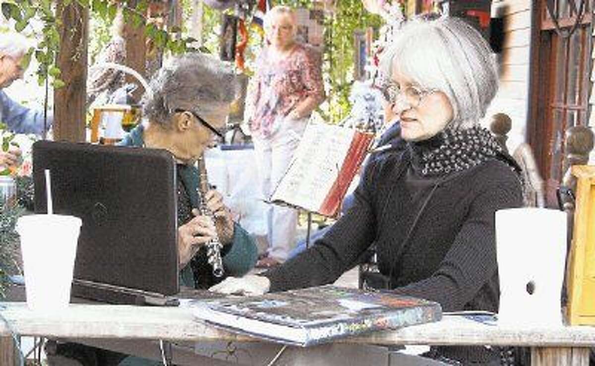 Helen Christine Bloomquist (left) and Lisa Schumaker (right) play soothing music during the Sue Ferguson Memorial fund.