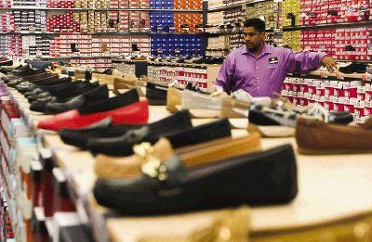 Store Manager Sam Arredondo checks inventory at Rack Room Shoes in the business' new location in The Woodlands off I-45 South and Lake Woodlands Dr. on the day of the store’s grand opening.