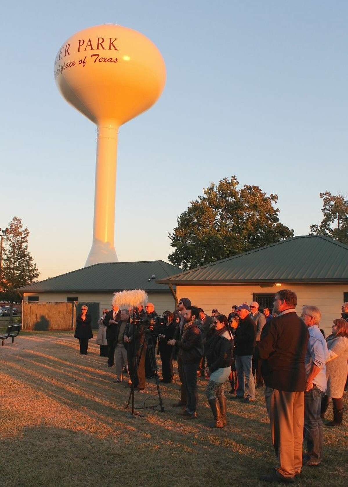 City representatives and residents listen in the shadow of the Deer Park water tower.