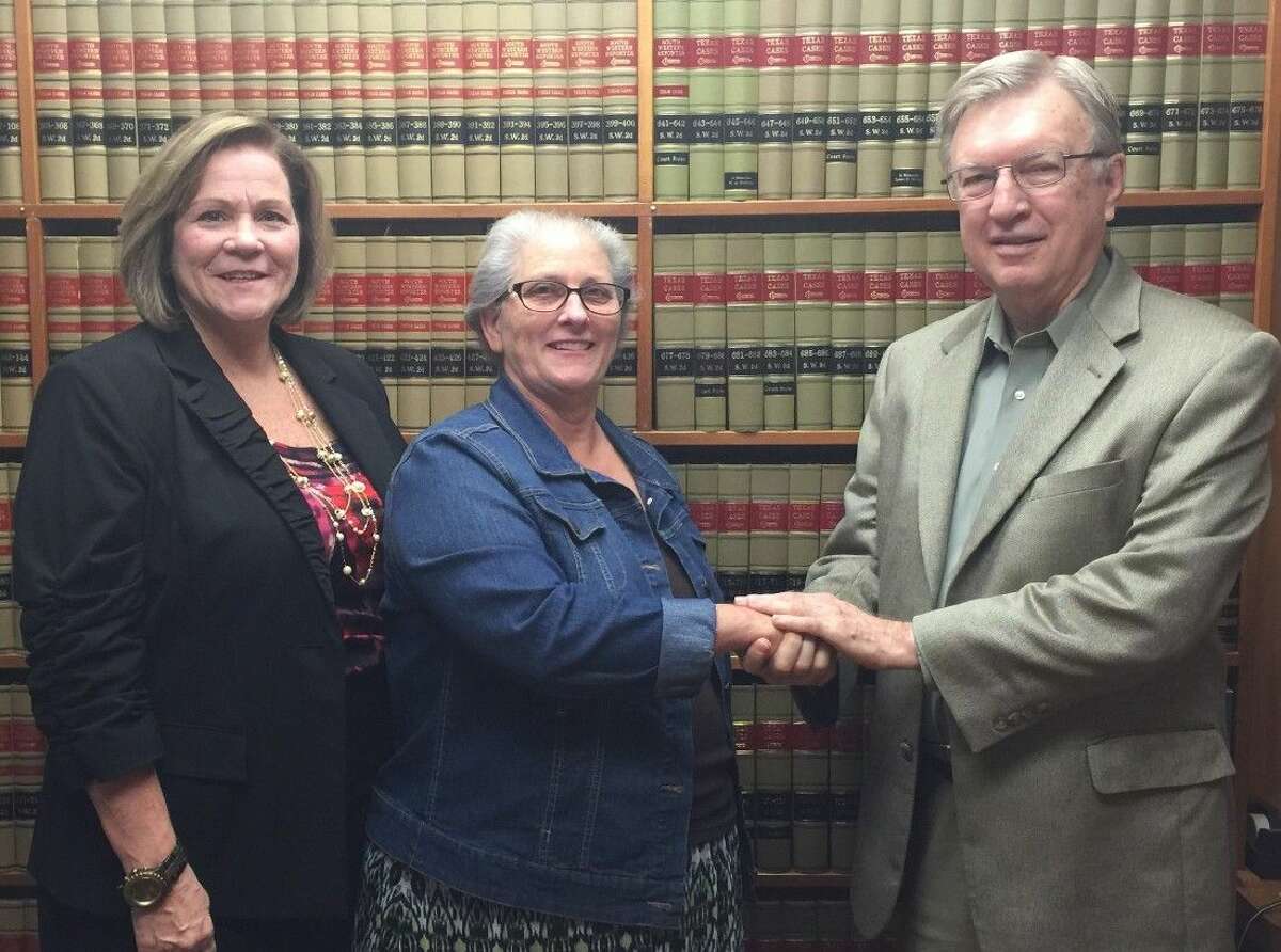 C. Bruce Stratton (right), on behalf of the Liberty County Bar Association and the State Bar, congratulates Debbie Dugger (left) and Kathy Dagle of CASA for receiving a $5,000 grant from the Texas Bar Foundation. The grant will be used for the Finding Family Program operated by CASA.