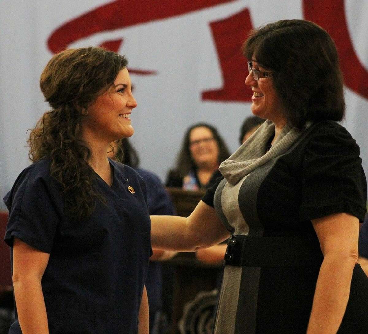ACC Nursing student Brooklyn Wilson, of League City, left smiles after receiving her nurse’s pin from Nursing Director Dr. Debbi Fontenot during a ceremony on December 12.