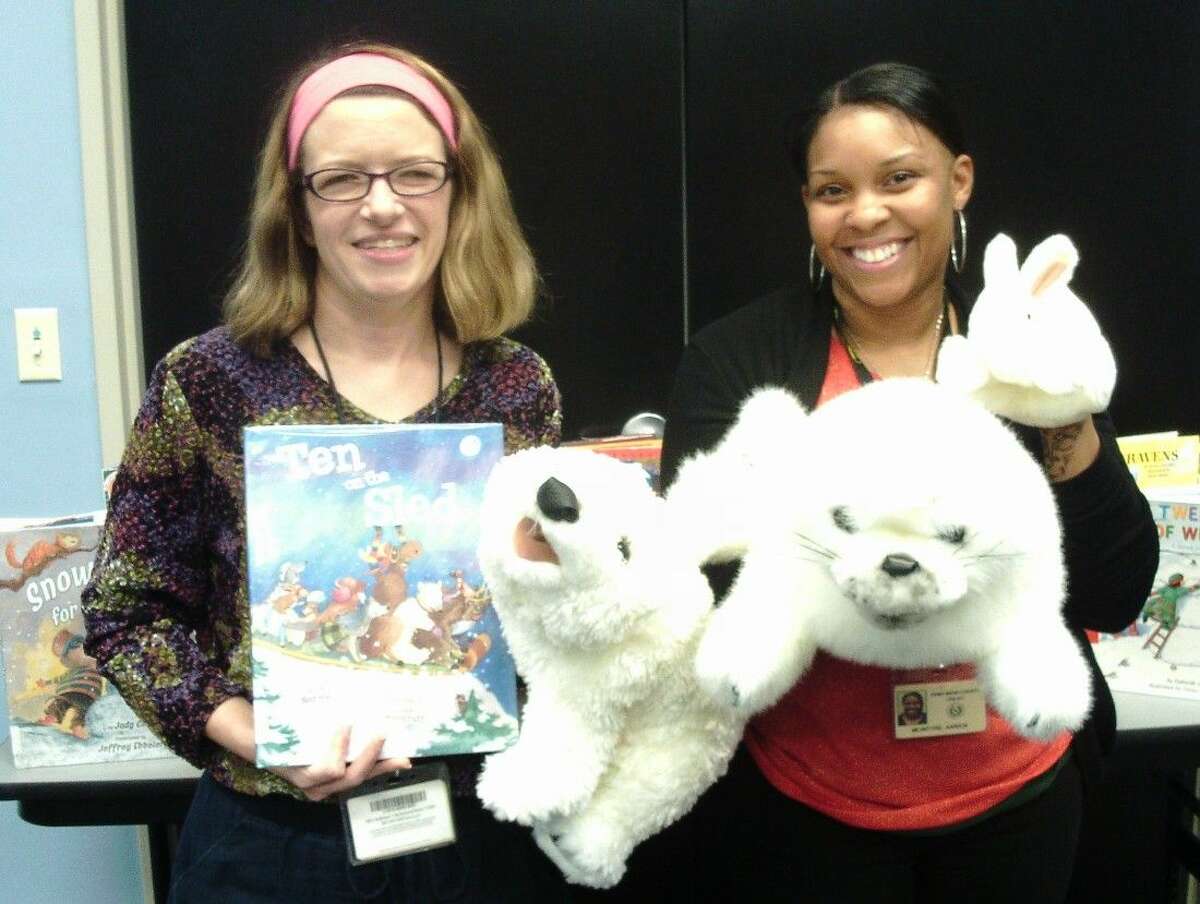 Laurie Jeffers (left) and Aarica McIntyre (right) display a few of the props used during Story Time at the Sugar Land Library, 550 Eldridge. The library strives to inspire learning and a love of reading.