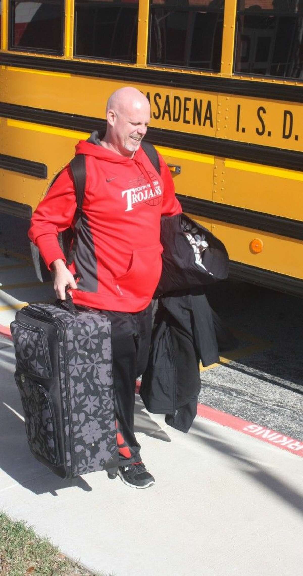 With suitcase and pillow, South Houston High School varsity boys basketball coach Patrick McCoy is all ready for his team's trip to Waco Monday afternoon. The red-hot Trojans, off to a 4-1 start in district, could see as many as four games in the Waco Tournament before returning home and the last 11 contests of district.