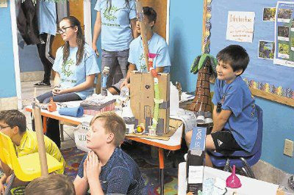 Campers work in groups to create ecological theme park attraction prototypes.