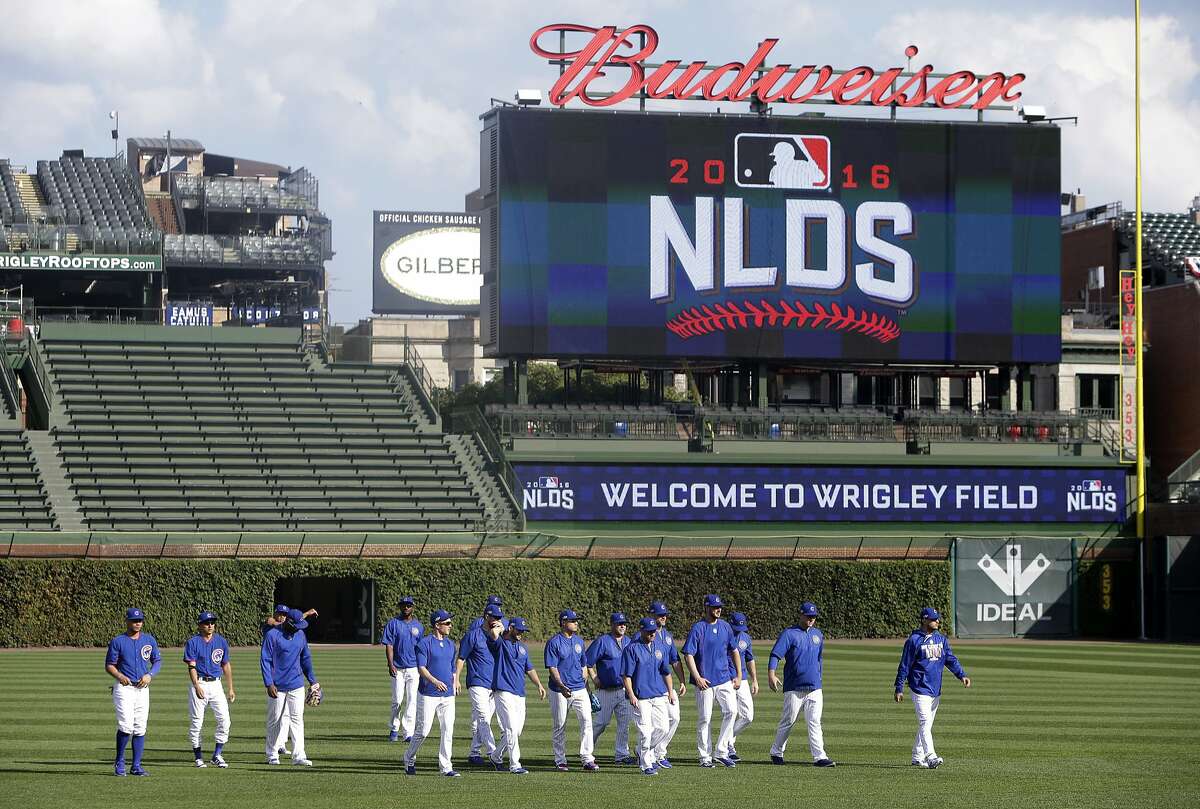 Chicago Cubs players warm up during baseball practice at Wrigley Field, Wednesday, Oct. 5, 2016, in Chicago. The Cubs host the winner of Wednesday's National League wild-card game between the New York Mets and San Francisco Giants on Friday, in Game 1 of the National League Division Series . (AP Photo/Kiichiro Sato)