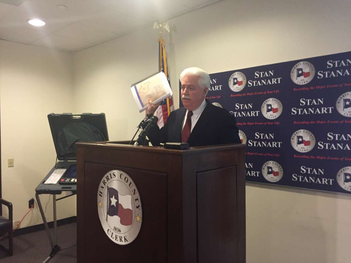 During a Thursday press conference, Harris County Clerk Stan Stanart holds up a copy of the 596-page Texas Election Code to stress the meticulous detail behind conducting an election.