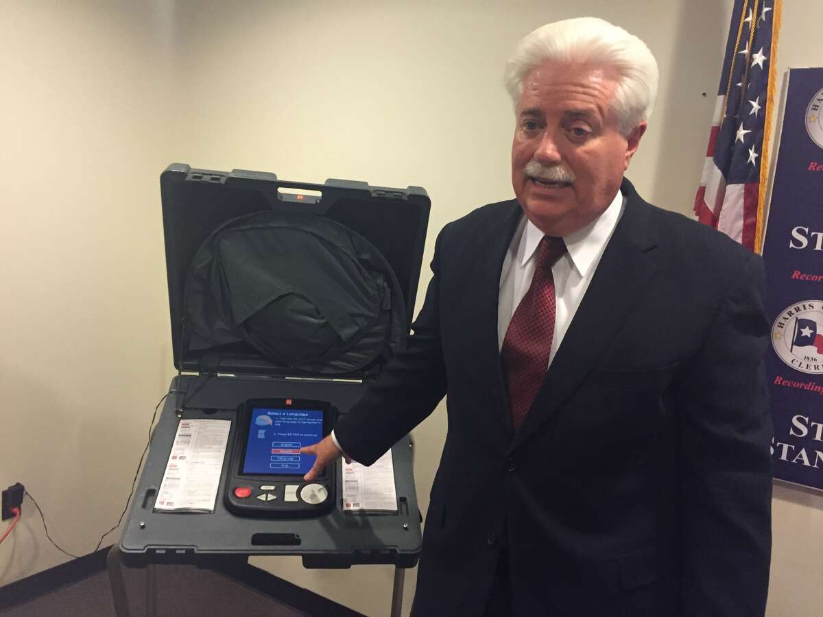 Harris County Clerk Stan Stanart exhibits a voting machine used in Harris County, which he said can't be hacked because it isn't connected to the internet.