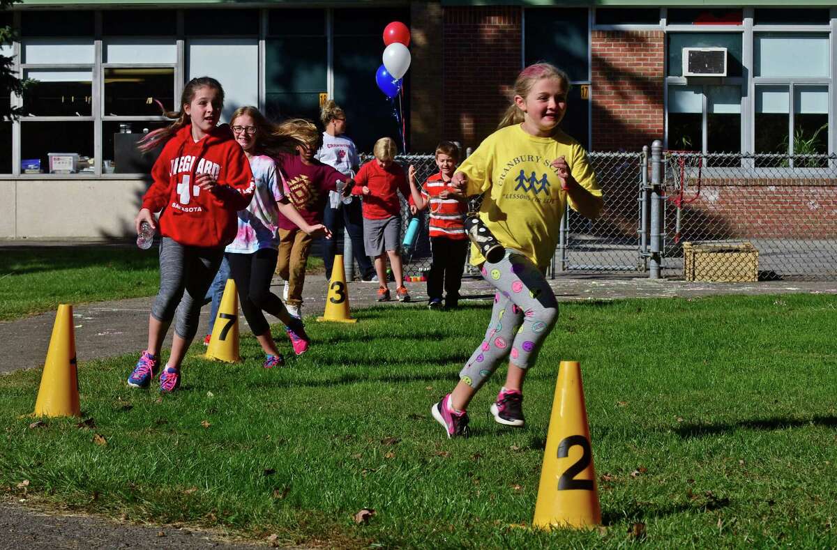 Cranbury Elementary School 4th grader, Kate Putterman, leads her class in the school's annual Walk-a-thon Thursday, October 6, 2016, in Norwalk, Conn.