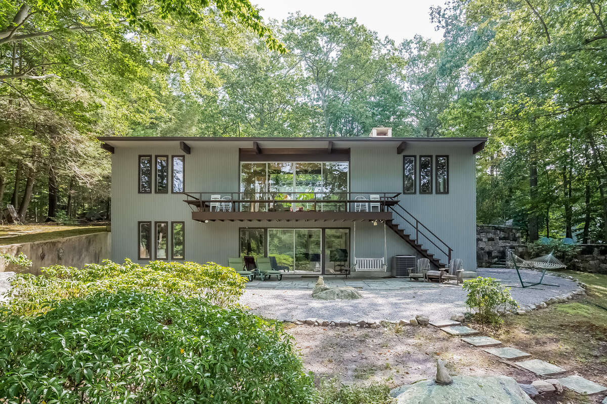 The glass-covered back of the midcentury modern home in North Stamford, which is on the market for $1.3 million.