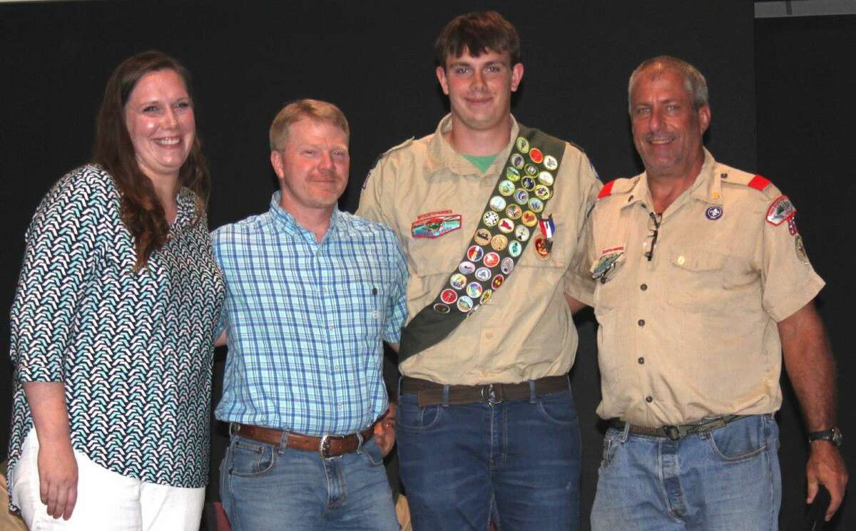 Eagle Scout Caleb Wilson (second from right) presented his parents, Amanda (left) and Doug Wilson (second from left), with their Eagle Scout Mom and Eagle Scout Dad pins, while giving Troop 95 Scoutmaster Ben Hankins (right) the Eagle Scout Mentor pin.