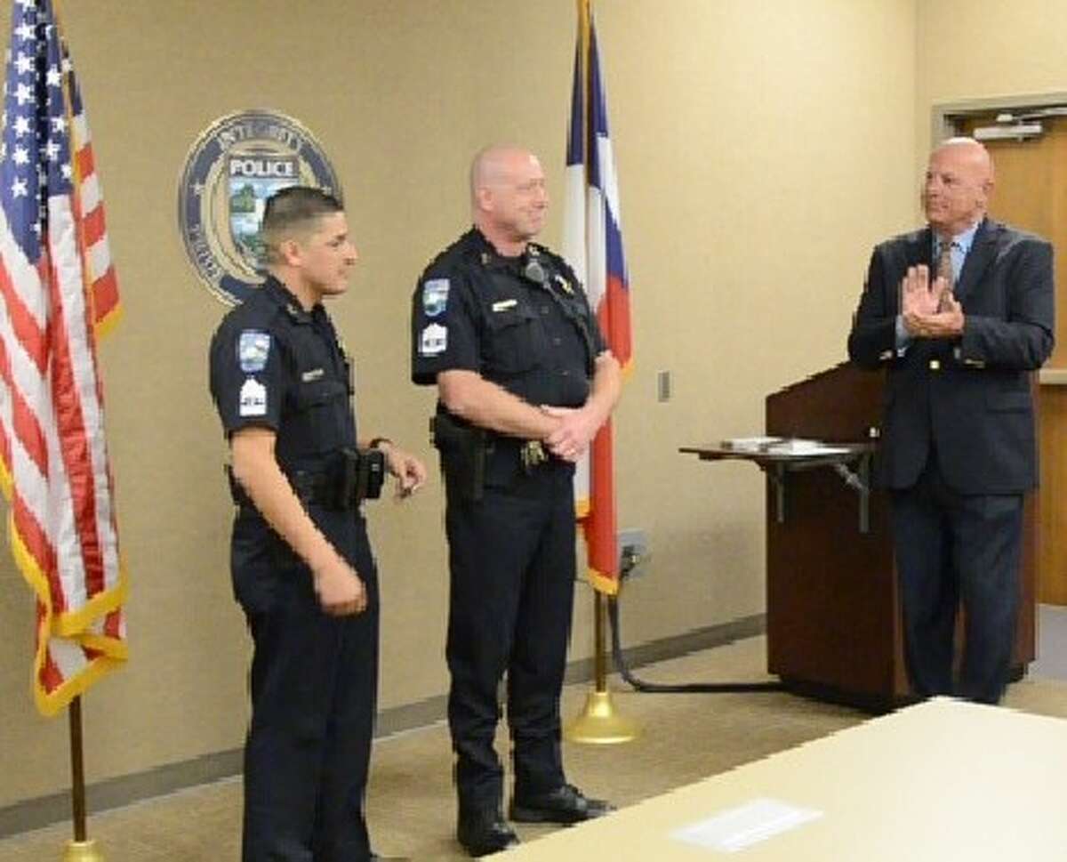 Pearland Police Chief J.C. Doyle (right) congratulates with newly promoted Sgts. Ornaldo Ybarra (left) and David Pratt after they were sworn in at a ceremony held at the Pearland Police Station.