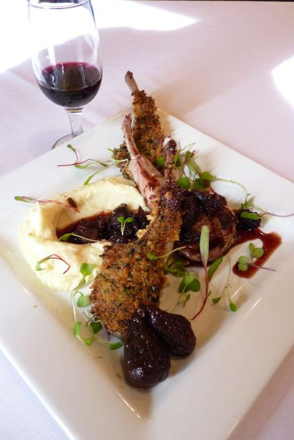 Herb Crusted Rack Of Lamb over celery root puree and topped with a fig cabernet sauce.