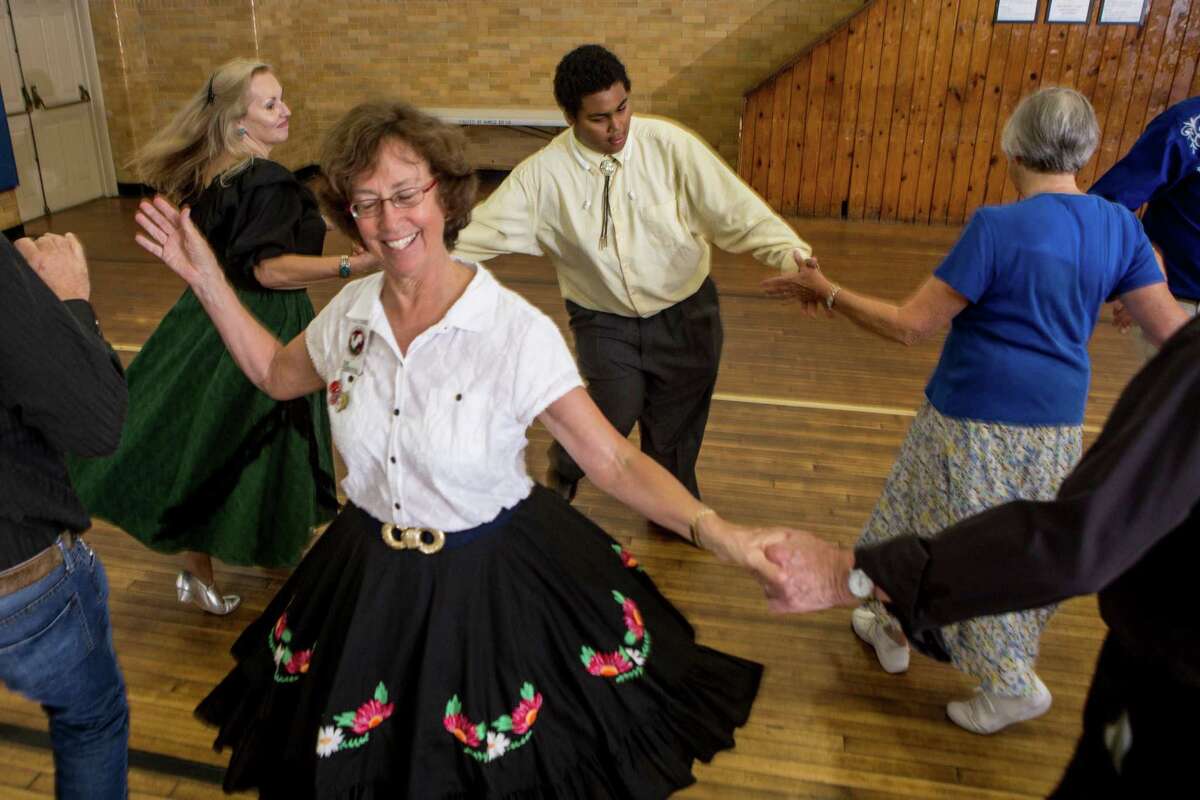 Sue Ruscitto, 67, of Southbury, is spun by Norman Lipofsky, of Monroe, while the song “Rock ’n Roll Lullaby” plays. They were just two of many who square danced at Edmond Town Hall in Newtown, where the Rocking Roosters Square Dancing Club recently met.