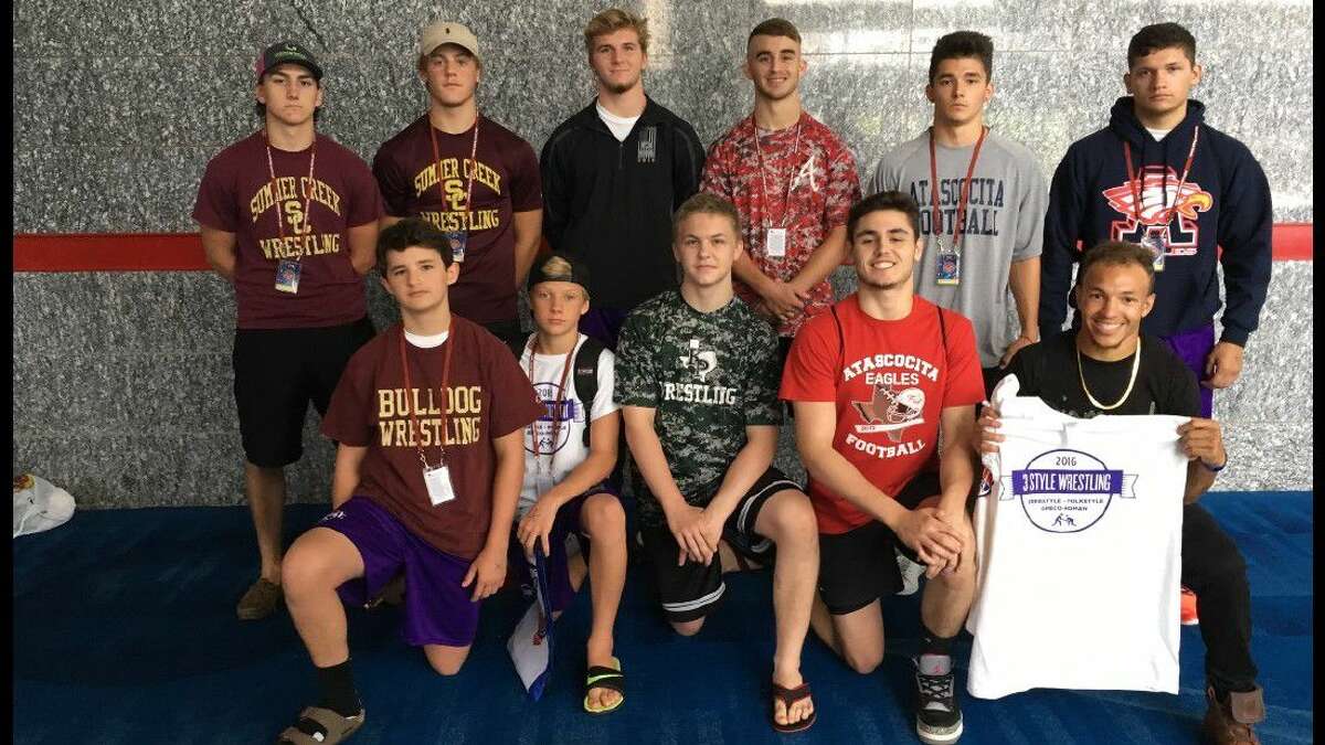 During the school wrestling season these athletes wrestlers fiercely represent their school on the mat, but outside school they train and compete together in club wrestling freestyle and Greco season at 3 Style Wrestling in Atascocita with Coach Derrick Waldroup, a former Olympian. ). Front row from left: Seth Durham (SCHS), Irisch Prochaska (QECHS), Nate Sandquist (KPHS), Dillon Mouser (AHS), Coach Devon Jackson. Back row from left: Nathan Schutt (SCHS), Logan Leatherwood (SCHS), Matt Dean (KHS), Hunter White (AHS), Joshua Escobedo (AHS), Pedro Villarreal (AHS
