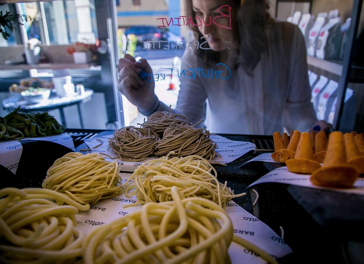 Julia Middlemiss writes the fresh pasta names on the case at Barzotto in San Francisco.