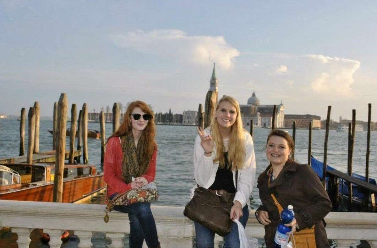 Three girls pose in Venice during the 2016 spring break trip to Italy.