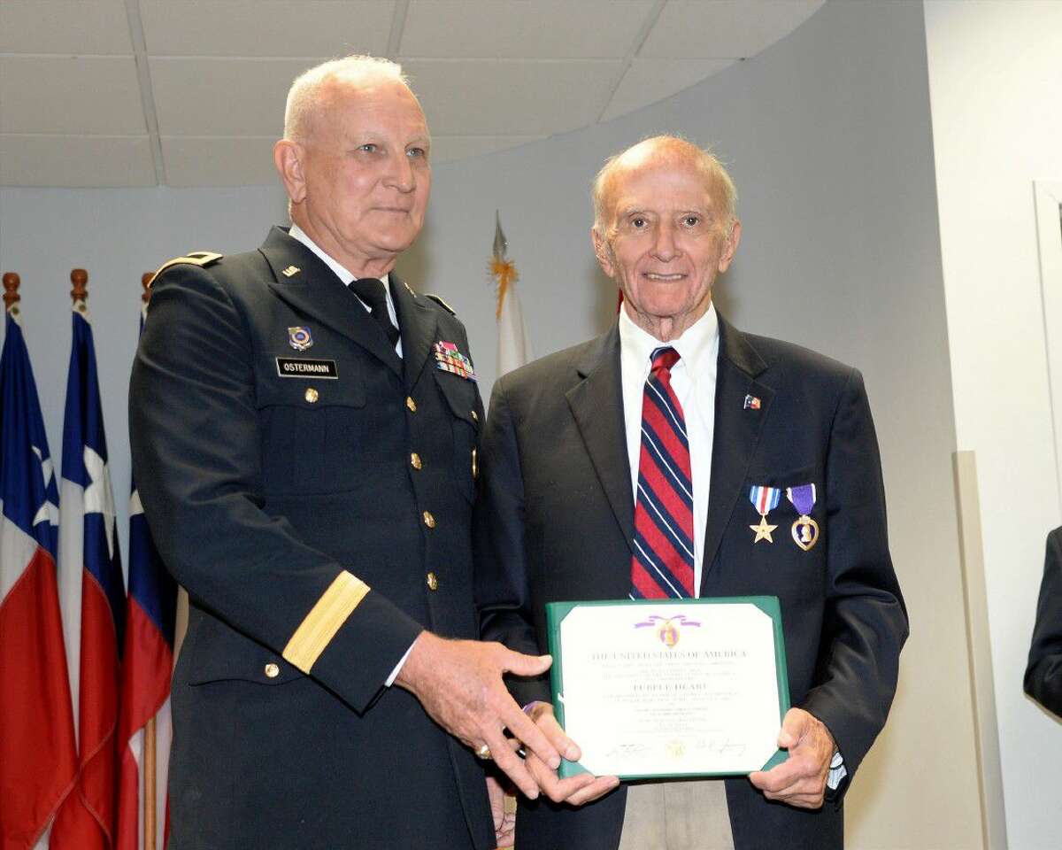 A representative of the United States Army presents James Duncan with the Purple Heart at the Tracy Gee Community Center in recognition of Duncan's service during the Korean War on Sept. 1.
