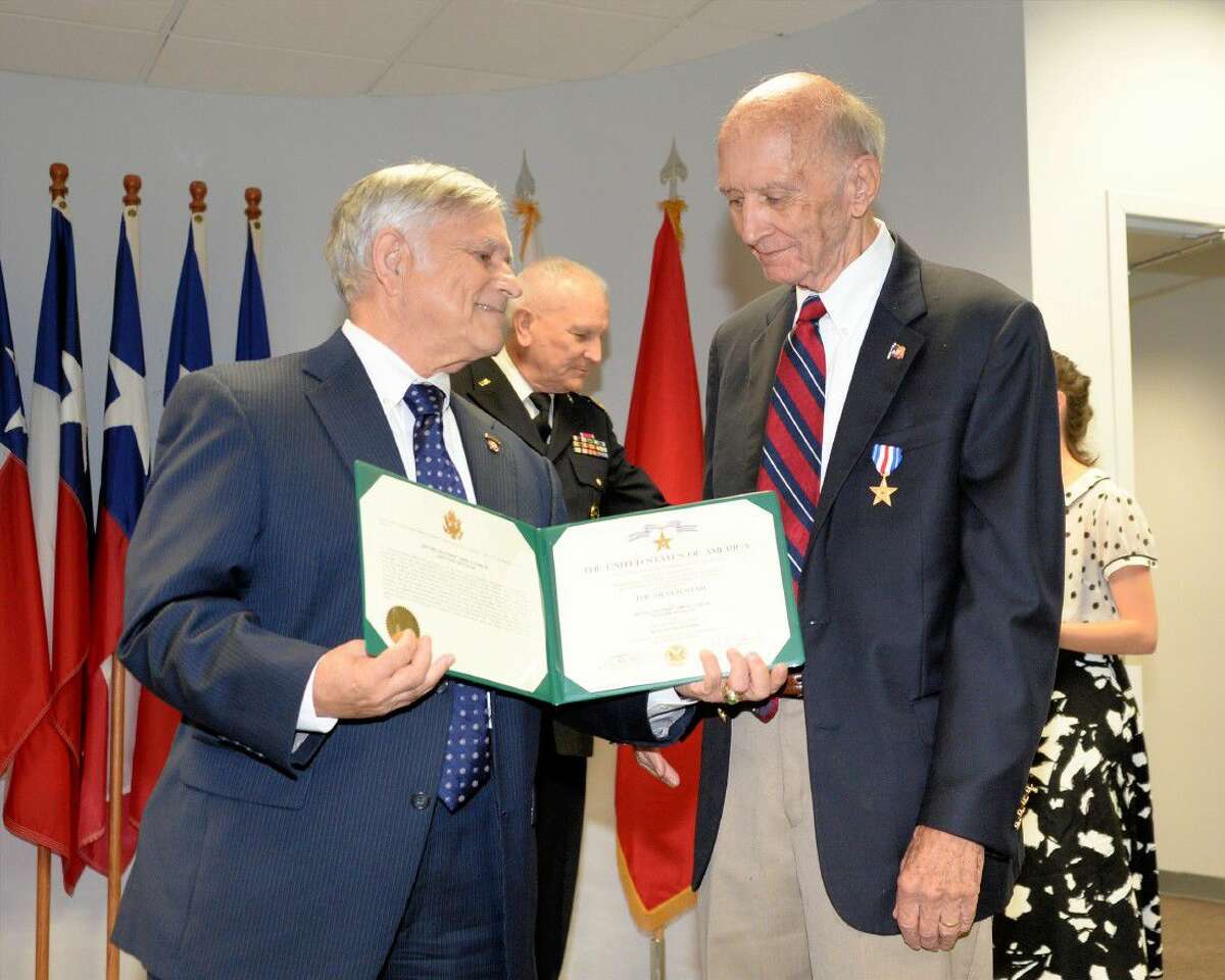 A representative of the United States Army presents James Duncan with the Silver Star at the Tracy Gee Community Center in recognition of Duncan's service during the Korean War on Sept. 1.
