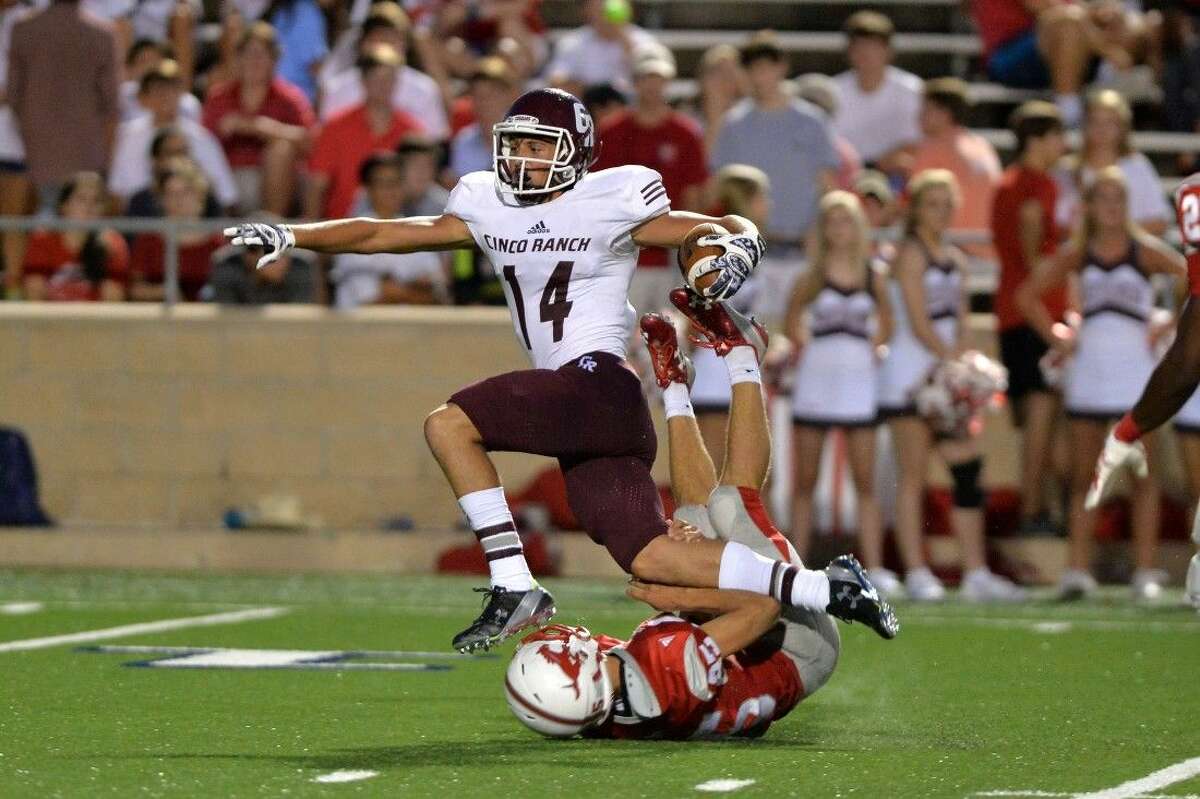 Cinco Ranch's Brant Kuithe hurdles a Memorial defender during a 41-yard reception during their 2015 game at Tully Stadium. Kuithe scored three touchdowns Sept. 8 as the Cougars defeated Memorial 51-0.