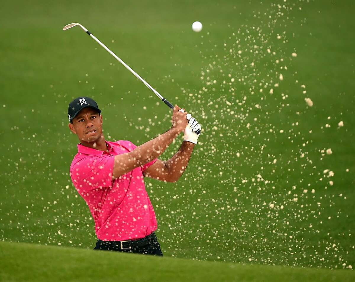 (FILES) This file photo taken on April 7, 2015 shows Tiger Woods of the US hitting out of the sand at Augusta National Golf Club in Augusta, Georgia during a practice round for the 2015 Masters Golf Tournament. Tiger Woods said September 7, 2016 he hopes to return to competitive golf next month at a tournament in California, but the 14-time major champion warned his much-anticipated return would depend on his continued recovery. "My rehabilitation is to the point where I'm comfortable making plans, but I still have work to do," the 40-year-old Woods, who has not played competitively since August 2015, said in a statement. / AFP PHOTO / TIMOTHY A. CLARYTIMOTHY A. CLARY/AFP/Getty Images