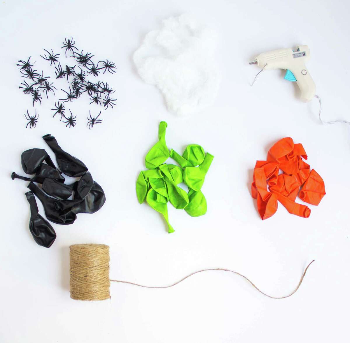 Materials 9- or 12-inch latex balloons in orange, black, and lime green (1 package of each is enough) Jute twine or string Small plastic spiders (you can buy these in a pack of 144 from OrientalTrading.com) Faux spiderweb Hot glue gun