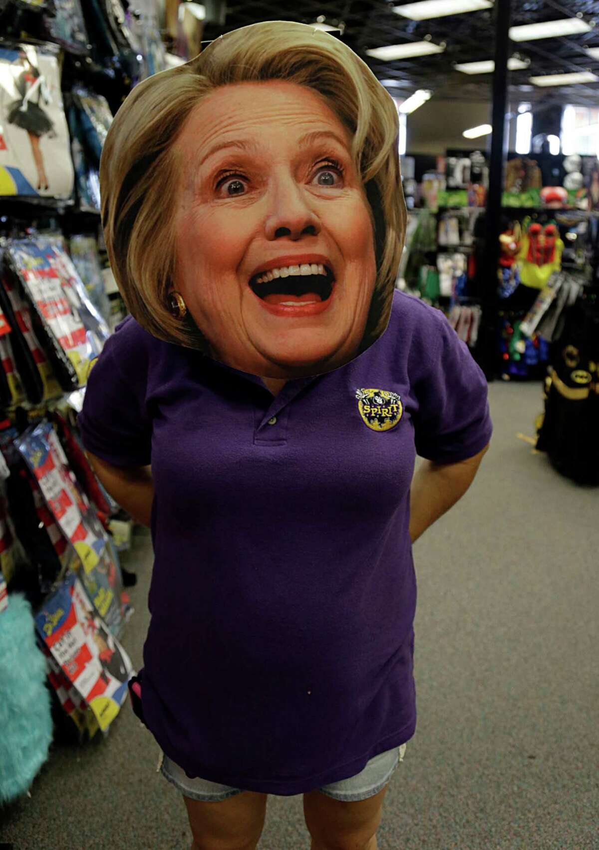A Spirit Halloween store, manager wears a Hillary Clinton mask Oct. 7, 2016, in Houston.