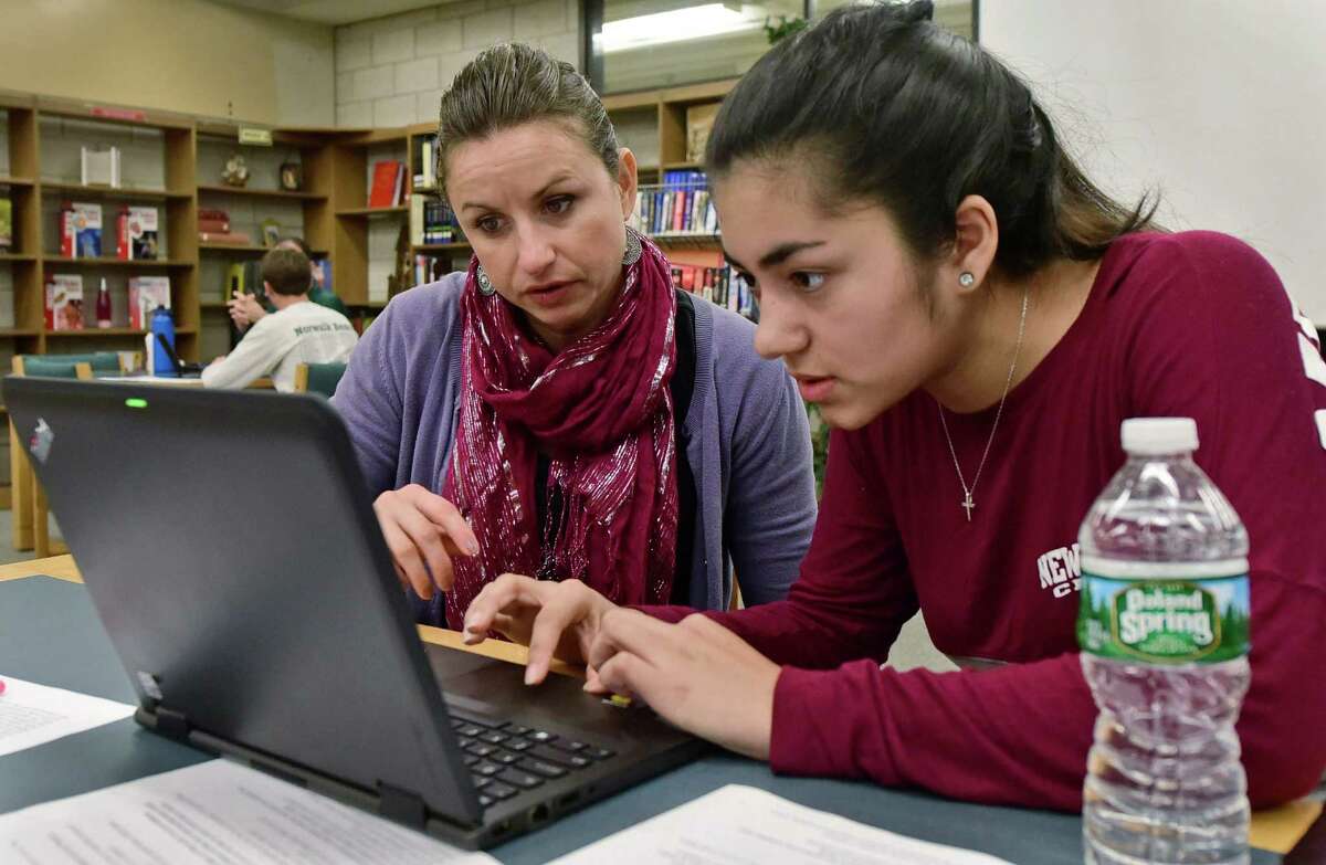 Norwalk High School English teacher, Maja Hodzic works with senior, Ariana McNulty, as the Norwalk Education Foundation's college and career readiness initiative holds a college essay mentoring workshop Friday, October 7, 2016, at the school in Norwalk, Conn.