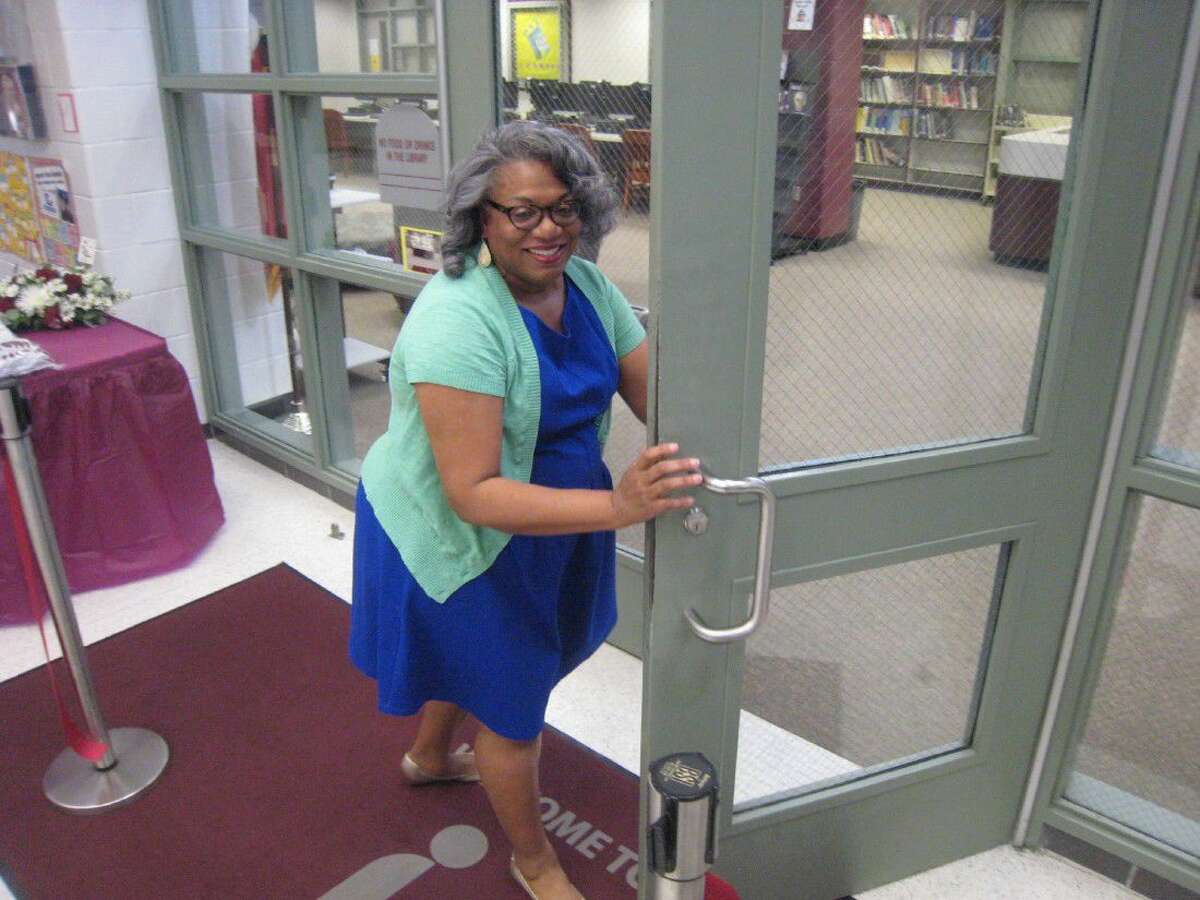 Timberwood Middle School librarian Sue White welcomes guests into the newly renovated library during the ribbon cutting ceremony Sept. 22.