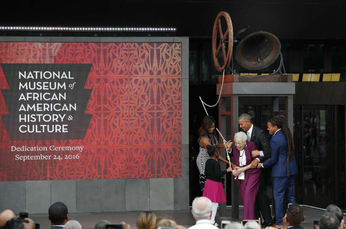 President Barack Obama and first lady Michelle Obama, ring the Freedom Bell: First Baptist Church of Williamsburg, with members of the Bonner family at the dedication ceremony for the Smithsonian Museum of African American History and Culture on the National Mall in Washington, Saturday.