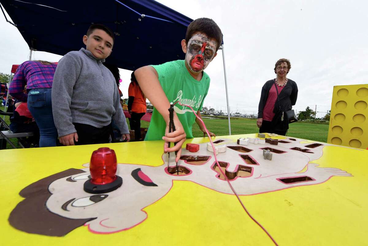 Joshua Hinojosa watches as Jackson Salmeiri plays operation during The Human Services Council?’s 5th Annual KIDZFEST Touch-A-Truck & More Fundraiser to benefit Children?’s Connection Saturday, October 8, 2016, at Taylor Farm Park, in Norwalk, Conn. KIDZFEST offers an opportunity for families to explore construction, emergency and recreation vehicles of all sizes as well as enjoy train rides, face painting, characters meet and greet, food, and games.