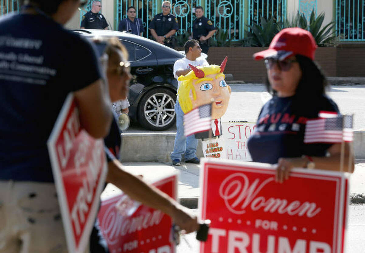 Rallying, but not alone The "Latinos for Trump" supporters encounter a small group of anti-Trump supporters while rallying on Navigation Boulevard Saturday, Oct. 8, 2016, in Houston.