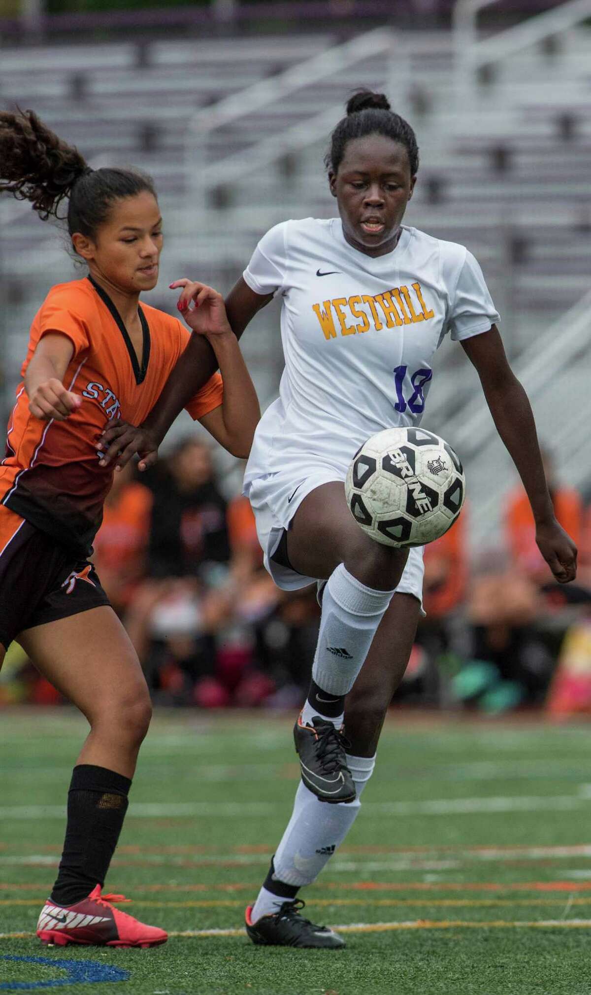 Westhill’s Chelsea Domond, right, and Stamford’s Estefanie Cabrera fight for the ball during a girls soccer game played at Westhill High School in Stamford on Saturday. Domond scored two goals to help Westhill capture the city championship, 3-0.