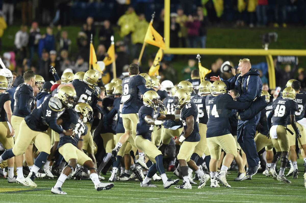 ANNAPOLIS, MD - OCTOBER 08: Navy Midshipmen fans run on the field after a football game against the Houston Cougars at Navy-Marines Memorial Stadium on October 8, 2016 in Annapolis, Maryland. The Midshipman won 46-40.