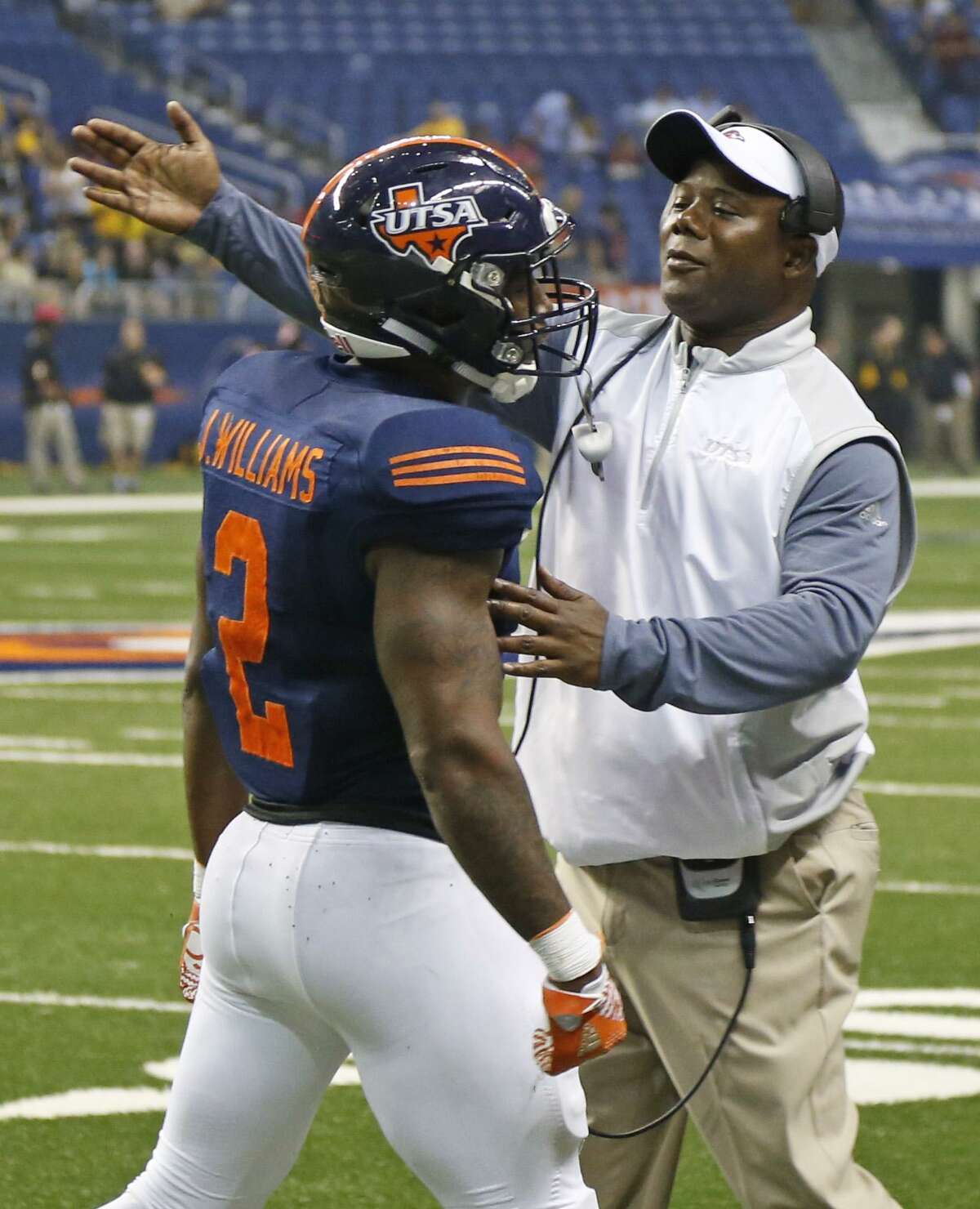 UTSA coach Frank Wilson congratulates Jarveon Williams after his TD run against Southern Miss at the Alamodome on Oct. 8, 2016.