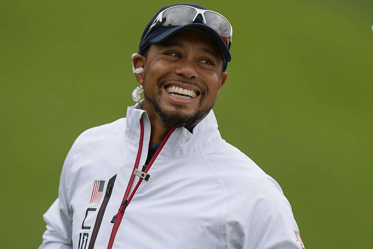 (FILES) This file photo taken on September 28, 2016 shows USA Vice-Captain Tiger Woods smiling during a practice round ahead of the 41st Ryder Cup at Hazeltine National Golf Course in Chaska, Minnesota. Woods confirmed on October 7, 2016, that he will return to action in California next week after a 14-month absence as he attempts to resurrect his flagging career.