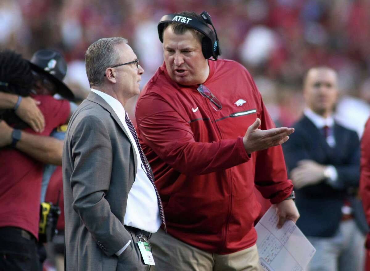 Arkansas coach Bret Bielema, right, talks to Athletic Director Jeff Long while officials review a play during the first quarter of Arkansas' NCAA college football game against Alabama on Saturday, Oct. 8, 2016, in Fayetteville, Ark. Alabama won 49-30. (AP Photo/Samantha Baker)