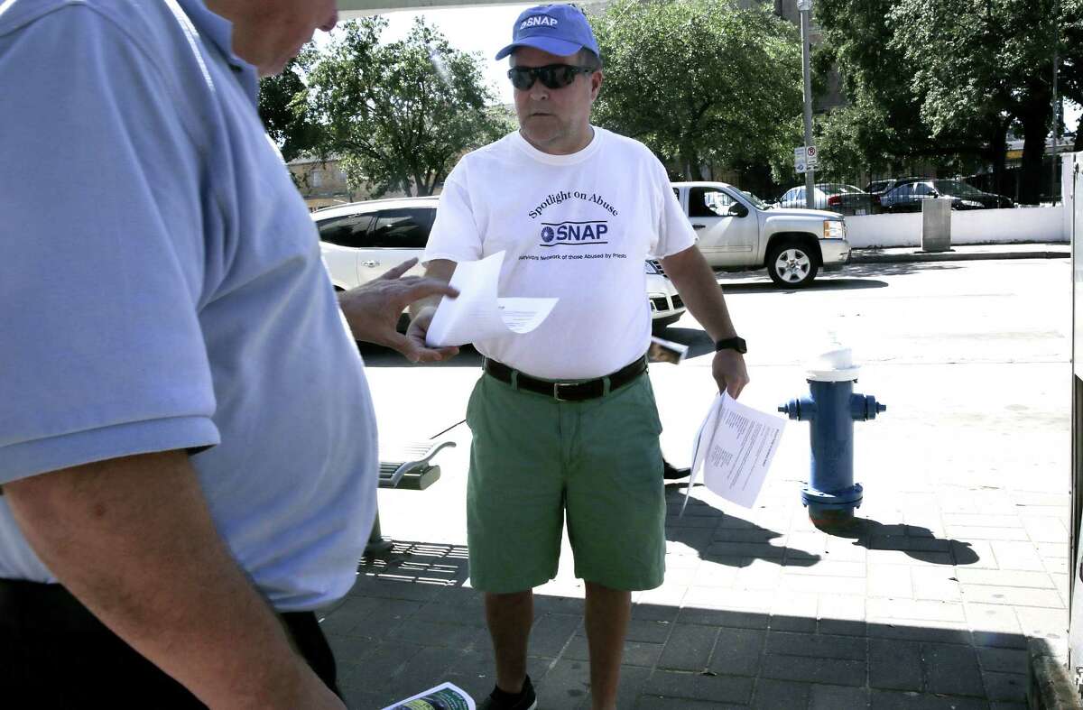 Michael Norris of Houston and member of SNAP passes out flyers outside the Co-Cathedral of the Sacred Heart on Sunday, Oct. 9, 2016, in Houston.