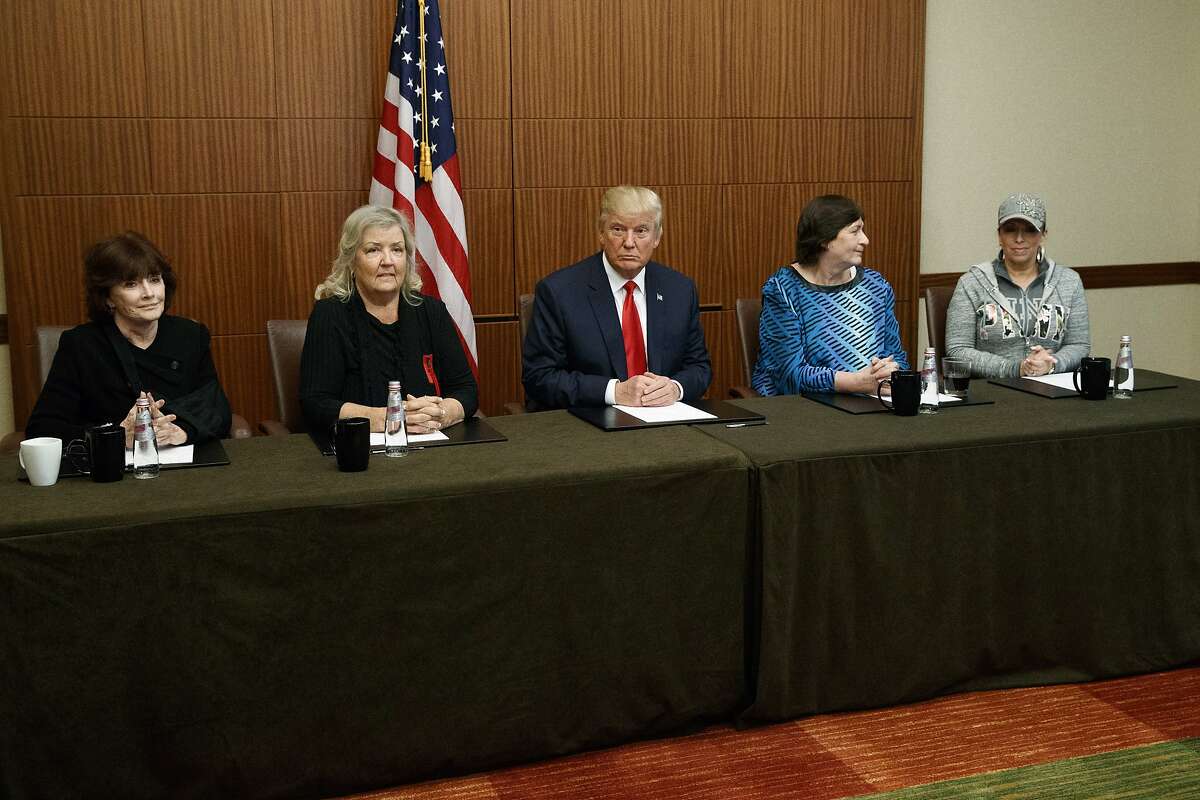 Republican presidential candidate Donald Trump, center, sits with, from right, Paula Jones, Kathy Shelton, Juanita Broaddrick, and Kathleen Willey, before the second presidential debate with Democratic presidential candidate Hillary Clinton at Washington University, Sunday, Oct. 9, 2016, in St. Louis. (AP Photo/ Evan Vucci)