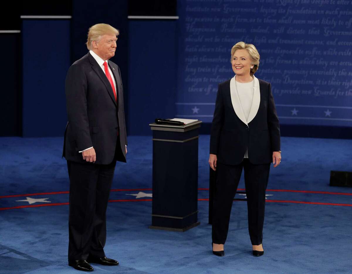 Republican presidential nominee Donald Trump and Democratic presidential nominee Hillary Clinton arrive for the second presidential debate at Washington University in St. Louis, Sunday, Oct. 9, 2016. (AP Photo/John Locher)