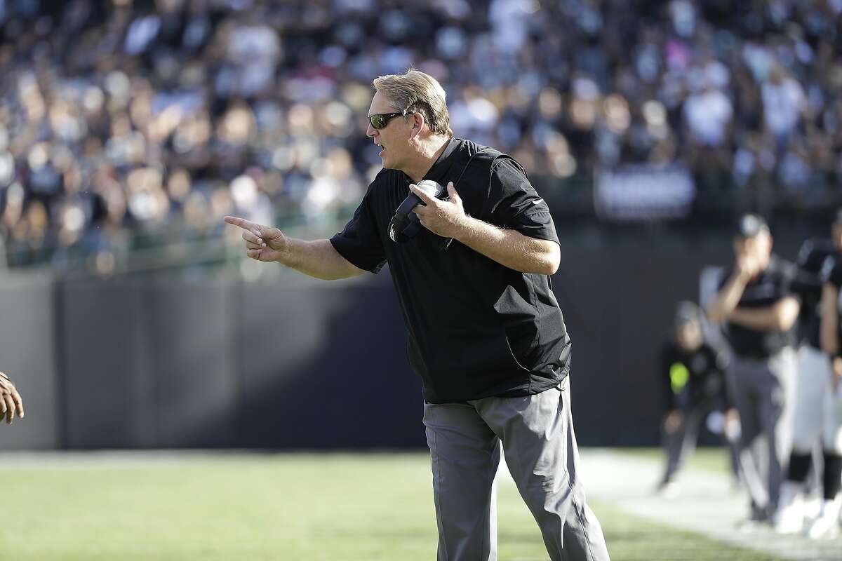 Oakland Raiders quarterback Derek Carr (4) and head coach Jack Del Rio  watch a replay during the second half of an NFL football game against the  San Diego Chargers in Oakland, Calif.