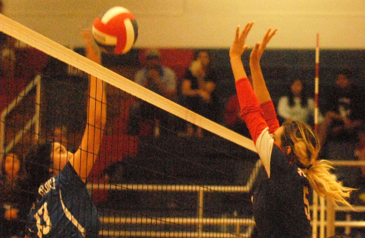 Plainview's Harlee Davis, right, goes above the net attempting to block a shot during a volleyball match earlier this season. The Lady Bulldog senior had eight kills and three solo blocks against Hereford Saturday.