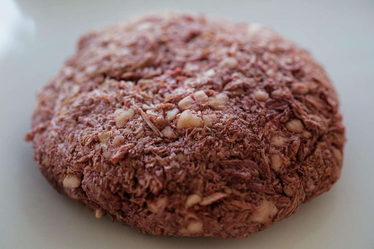 A raw non-meat burger rests on a tray, before being cooked, at the Impossible Foods headquarters in Redwood City, California, on Thursday, Oct. 6, 2016.