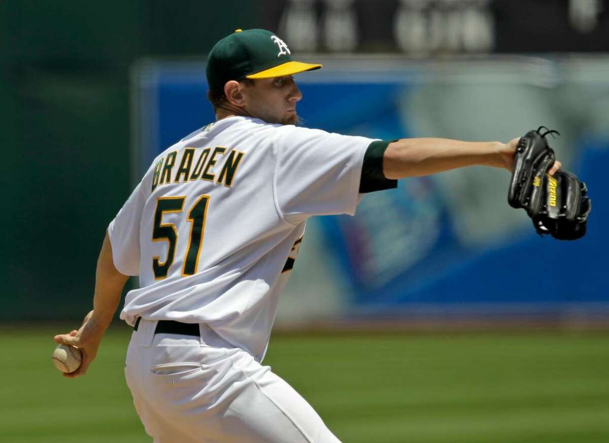 Oakland Athletics starting pitcher Dallas Braden throws to the Tampa Bay Rays during the third inning of a baseball game in Oakland, Calif. Sunday, May 9, 2010.