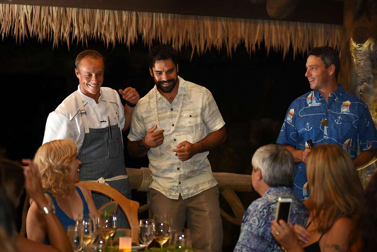 Mike Lofaro and cultural ambassador Kainoa Horcajo with diners during an episode of "Search Hawaii."