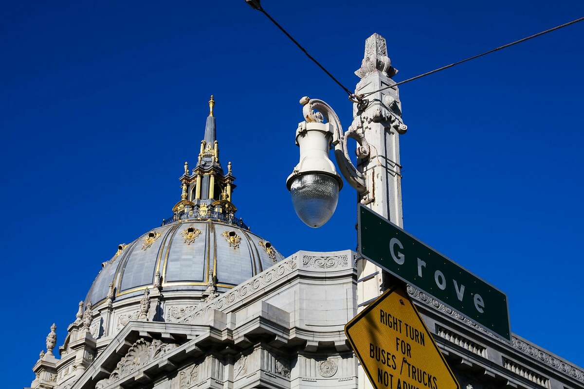 A historic street lamp is seen, with City Hall behind it, on Van Ness Avenue and Grove Street in San Francisco, California, on Monday, Oct. 10, 2016.