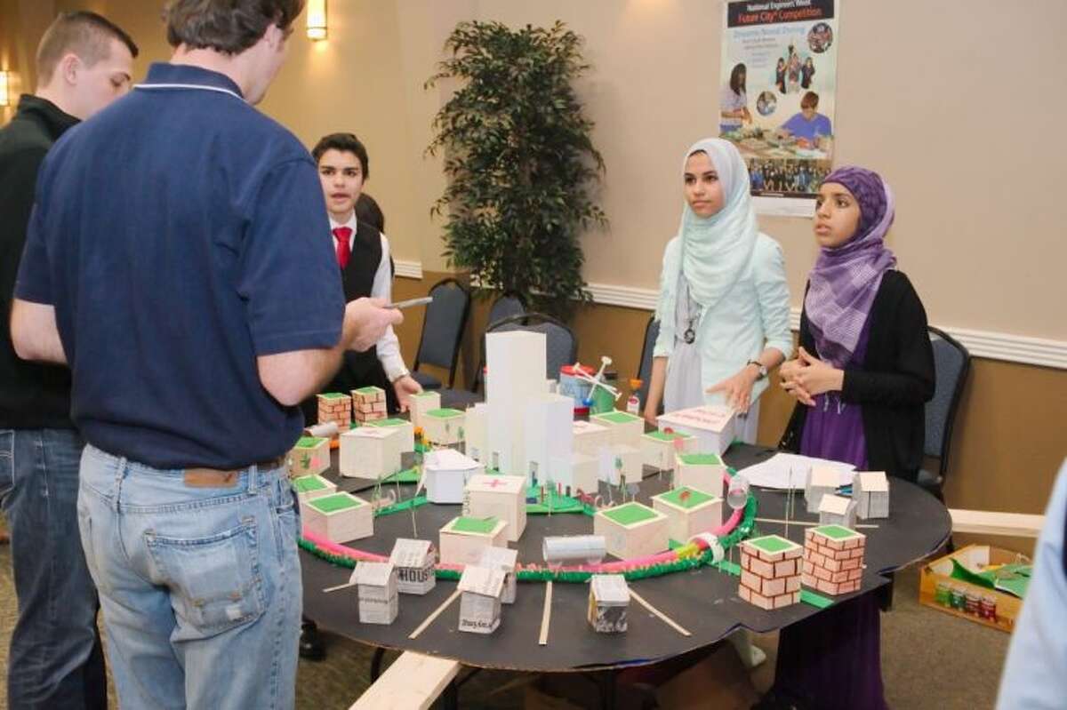 Inman Academy - Webster campus students Abraham Albaba, Nada Shalaby, and Fatima Islam present their project to judges during the Future City Competition, Tomorrow’s Transit: Design A Way To Move People In And Around Your City regional finals at Johnson Space Center Gilruth Center Saturday, Jan. 18.